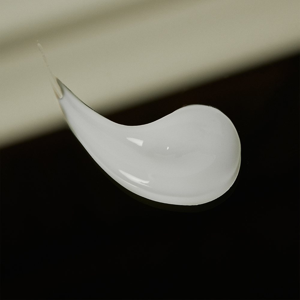 A swipe of the Hydrating Hand Sanitizing Serum's silky white texture